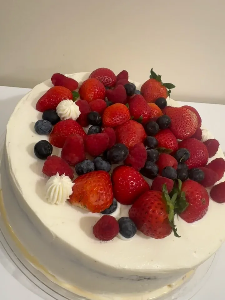 Fresh berry celebration cake with piped cream by Veronica Garcia
