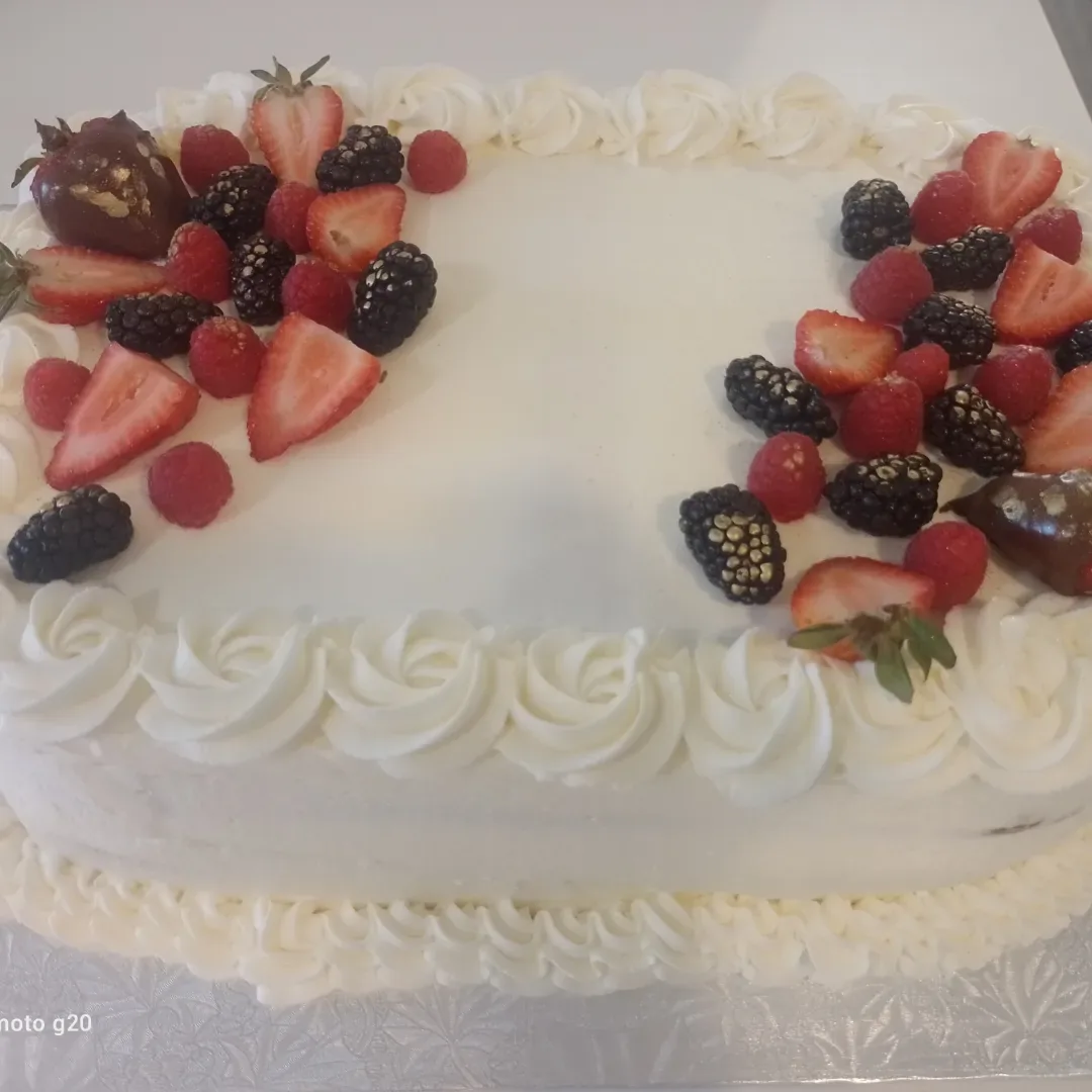 Tres leches cake finished with cream and fresh berries